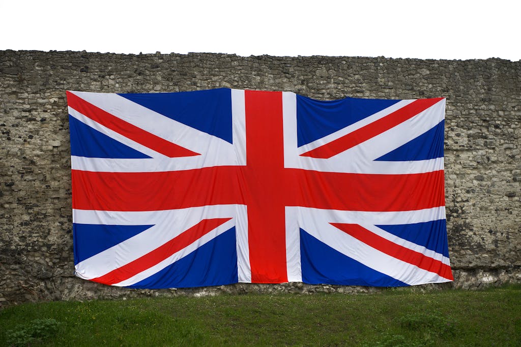 Union Jack flag draped over a historic stone wall, symbolizing British heritage in Rochester, England.